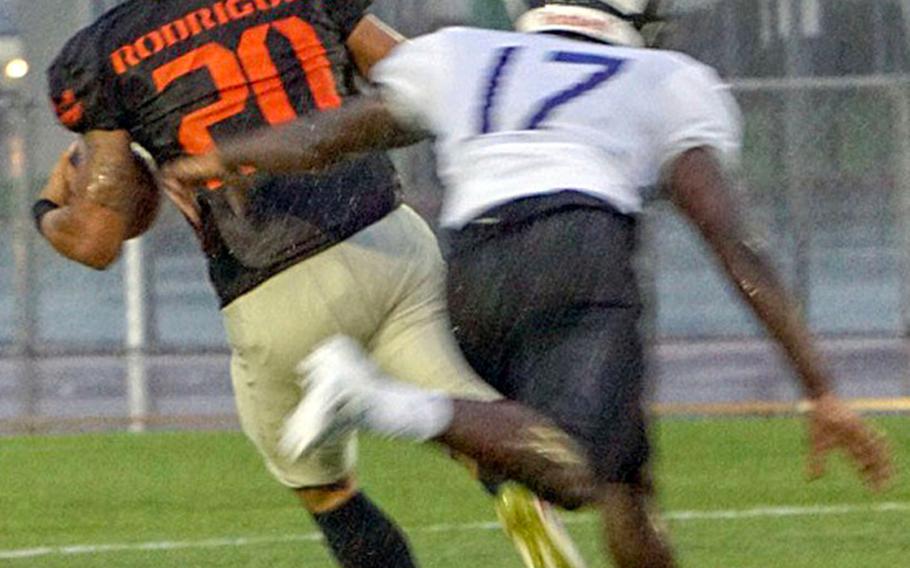 Hansen's Jeromy Rodriguez leaves Okinawa defensive back Keelan Jones in his wake. Rodriguez caught five passes for 120 yards and a touchdown to pace the Outlaws' offense.