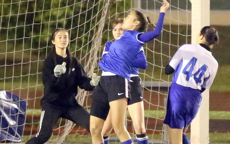 Yokota's Caleigh Garcia tries to settle the ball in front of goalkeeper Emily Taynton and Christian Academy Japan's Mei Kimura during Tuesday's Japan girls soccer match, won by the Panthers 2-0.