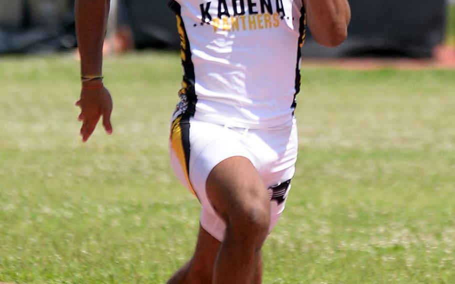 Kadena's Eric McCarter speeds to victory in the 100 during Saturday's Okinawa district finals.