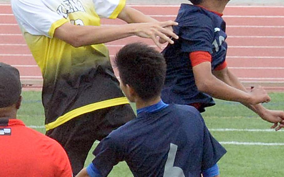 Kadena's Kael Beck tries to play the ball against Nanbu Shogyo during Saturday's Okinawa boys soccer match, won by the Panthers 3-1.