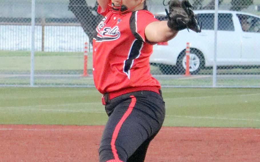Nile C. Kinnick's Tori Osterbrink kicks and delivers against Yokota during Friday's Japan softball game. Osterbrink struck out 14 Panthers and the Red Devils rallied for four runs in the last of the eighth inning to beat Yokota 6-4.