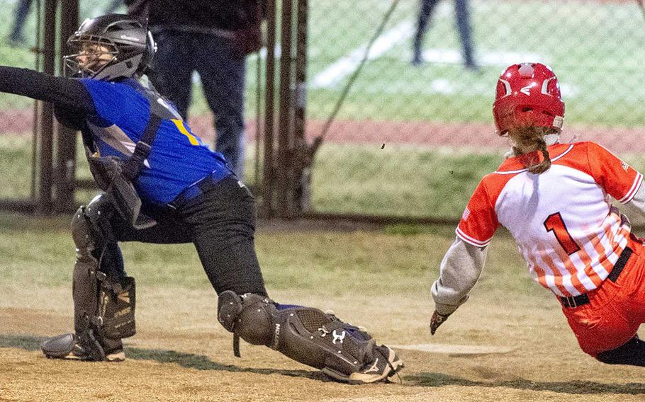 Catcher Becca Bauman is one of the players Yokota's softball team hopes can carry them to their first Division II title since 2016; Faith Sells, sliding, is one of newcomers on a Nile C. Kinncik team aiming for its second Division I title in three years.