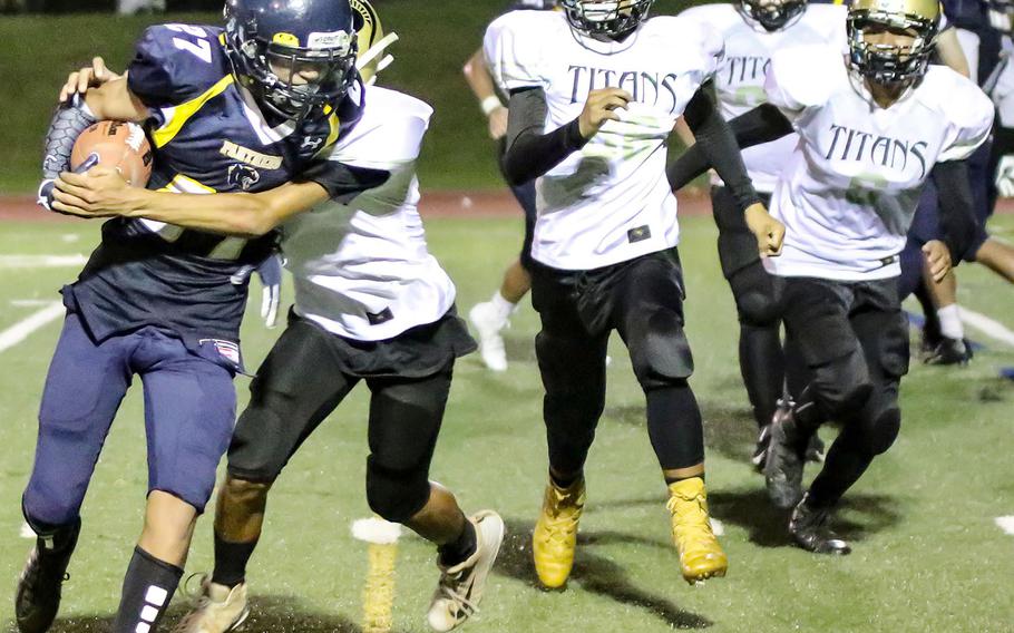 Guam High running back Eugenio Ramirez tries to elude several Tiyan defenders.