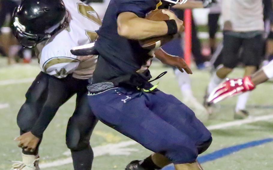 Guam High receiver Nicholas Keefe looks for room to run to the end zone for one of his two touchdown catches.