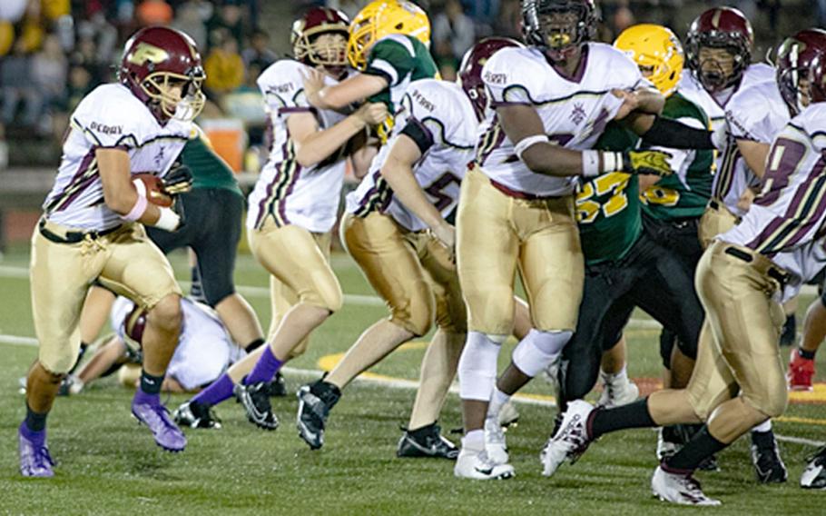 Matthew C. Perry running back Matthew Torrecillas follows teammates blocks around right end against Robert D. Edgren.