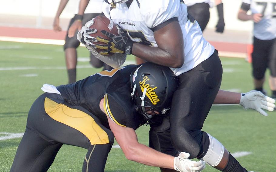 Humphreys running back David Key gets wrapped up by Kadena defender Ryker Hemmers.