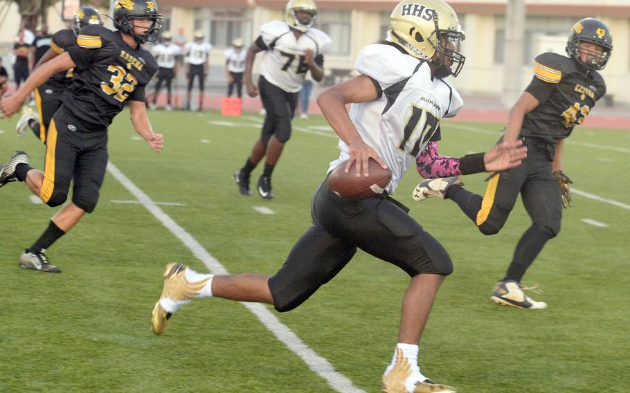 Humphreys quarterback Deontaye Gregory tries right end and tries to leave Kadena defenders in  his wake.