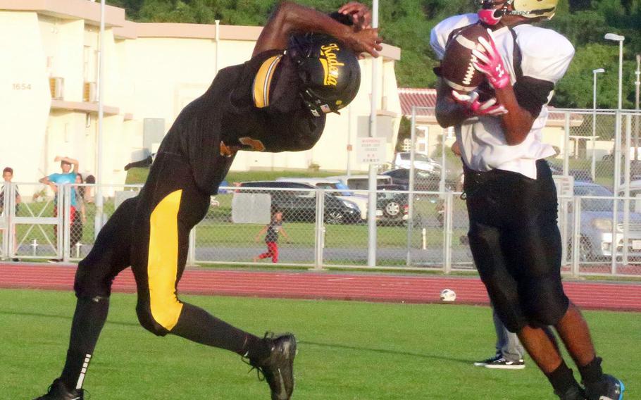 Humphreys receiver Junior Gregory lsnags a pass against Kadena's Xavier Peace.