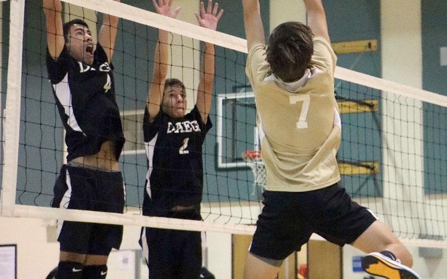 Humphreys' Abel Recheungel tries to bump the ball past Daegu's Joshua Dela Cruz and Aleiandro Miller during Wednesday's Korea boys volleyball match, won by the Blackhawks in five sets.