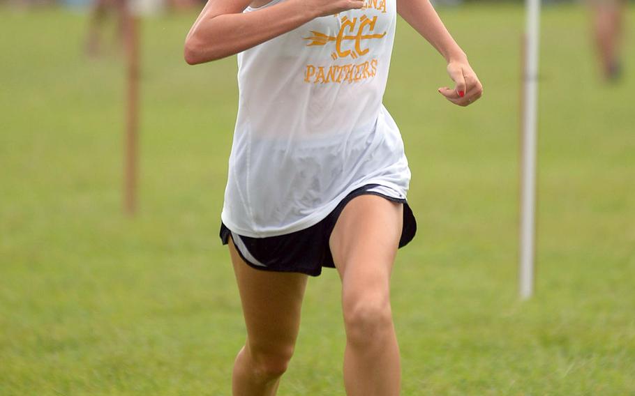Kadena sophomore Sara Corrado comes across the finish line first among high school-aged girls runners in 23 minutes, 5 seconds during Monday's Okinawa cross country race.