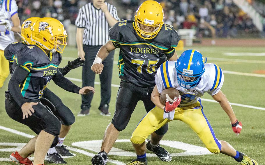 Yokota quarterback Brody Choate finds himself bottled up by the Robert D. Edgren defense.