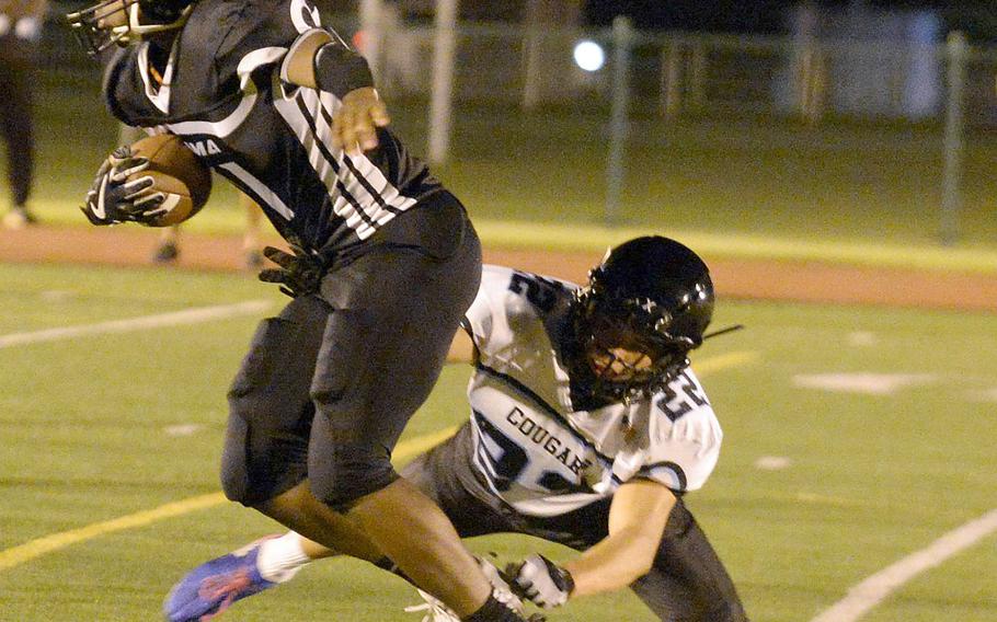 Zama's Brenden Jackson sheds a tackle by Osan's Marcus Inthavixay en route to a 20-yard catch-and-run for a touchdown.
