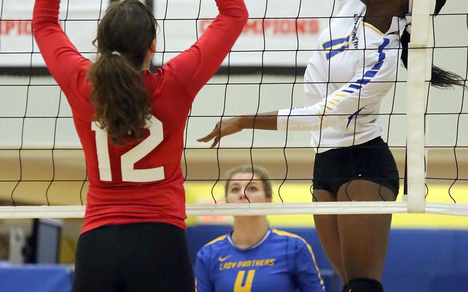Yokota's Haley Singleton hits against Nile C. Kinnick's Charlize Uptegrove during Tuesday's DODEA-Japan/Kanto Plain girls volleyball match, won by the Red Devils in three sets.