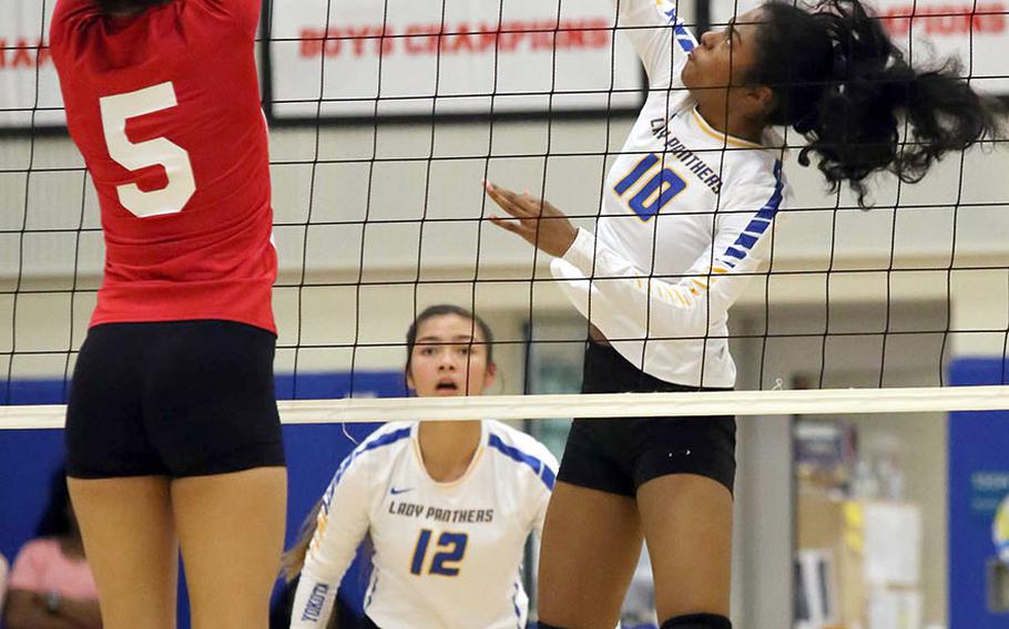 Yokota's Alexis Smalls spikes against Nile C. Kinnick's Ernestina Roberts during Tuesday's DODEA-Japan/Kanto Plain girls volleyball match, won by the Red Devils in three sets.