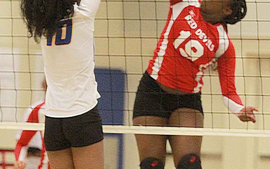 Nile C. Kinnick's Kiana Johnson prepares to spike against Yokota's Alexis Smalls during Tuesday's DODEA-Japan/Kanto Plain girls volleyball match, won by the Red Devils in three sets.
