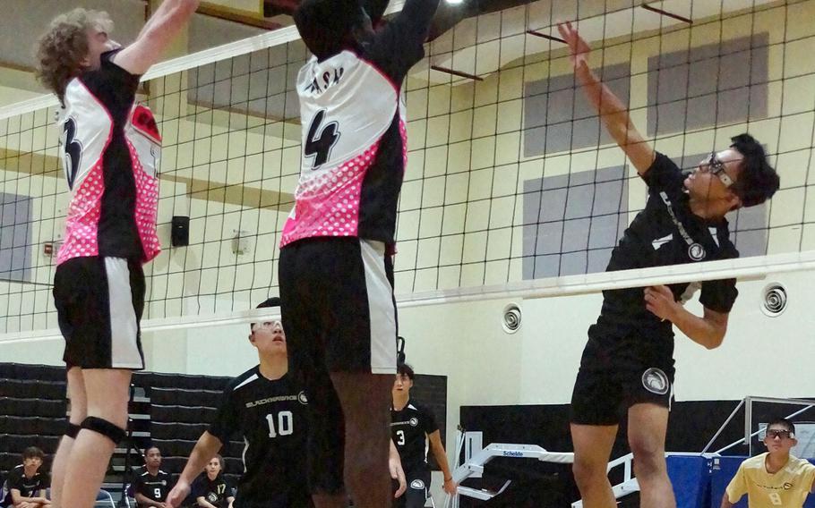 Humphreys' Matthew Oh drills a shot between Osan's Alexander Eaglin and Kemari Nash during Wednesday's Korea boys volleyball match won by the Blackhawks in four sets.