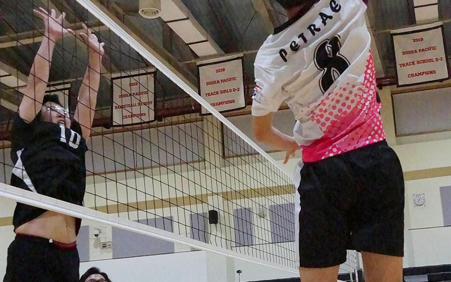 Osan's Timothy Petrae tries to place a shot past Humphreys' Marin Kwon during Wednesday's Korea boys volleyball match won by the Blackhawks in four sets.