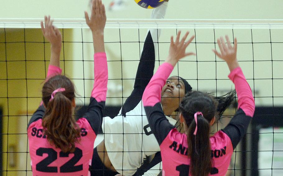 Humphreys' Jalynn Knight drills a shot between Osan's Kaiyana Schniers and Abigail Anderson during Wednesday's Korea girls volleyball match won by the Blackhawks in three sets.