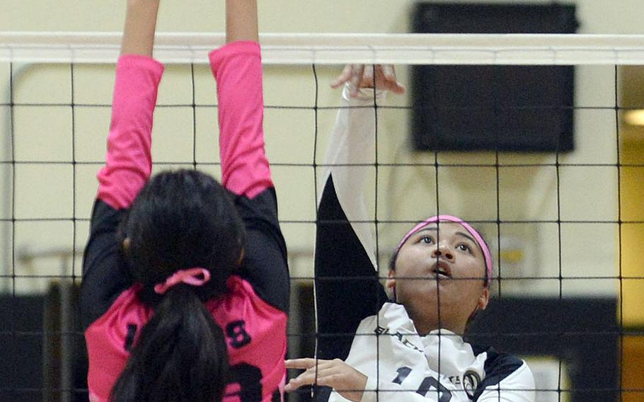 Humphreys' Alaina Areniego sends a shot past Osan's Shaylee Ungos during Wednesday's Korea girls volleyball match won by the Blackhawks in three sets.