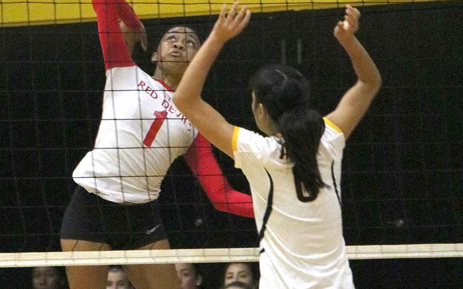 Nile C. Kinnick's Lynell Adepoju goes up to spike against American School In Japan 2 during Thursday's pool-play match in the 5th America School In Japan YUJO Volleyball Tournament. The Red Devils won in two sets.