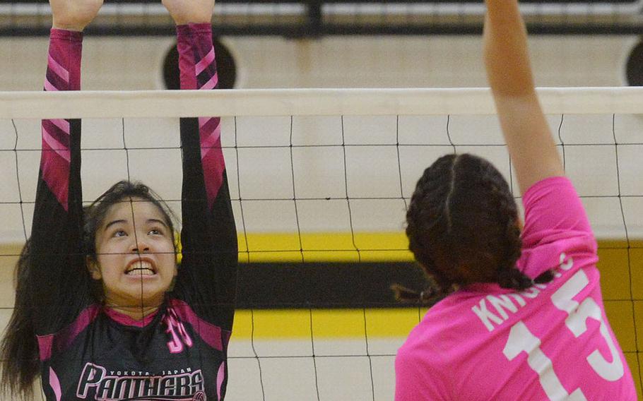 Christian Academy Japan's Mei Kimura hits against Yokota defender Liana Morrow during Thursday's pool-play match in the 5th American School In Japan YUJO Volleyball Tournament. The Panthers won in three sets.