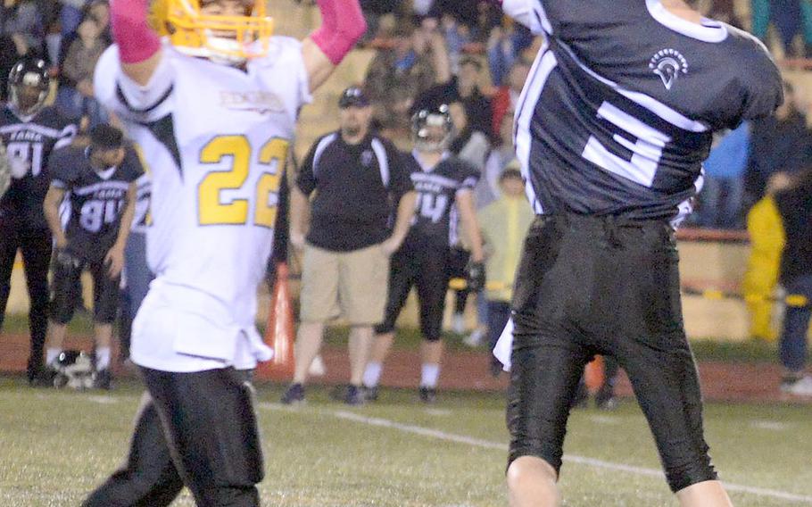 Zama quarterback Tim Matelski unleashes a pass over Robert D. Edgren defender Douglas Tackney.