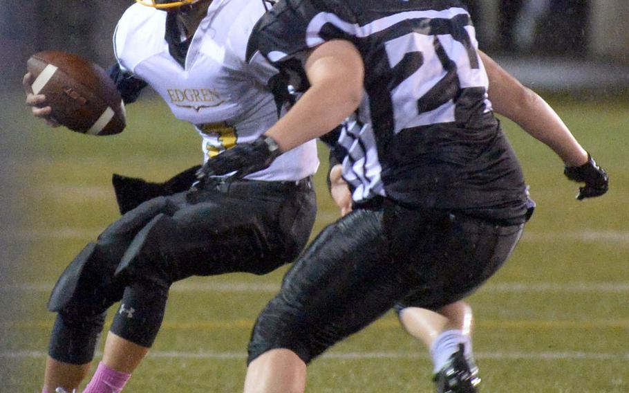 Robert D. Edgren quarterback Dylan Tomas finds himself boxed in by Zama defensive back Liam Thompson.