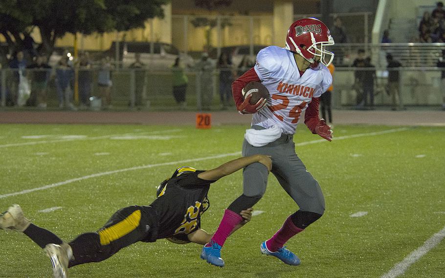 Daniel Burke, a wide receiver for the Nile C. Kinnick Devils, runs the ball during a game against the Kadena Panthers at Habu Field on Kadena Air Base, Okinawa, Japan, Friday, Oct. 18, 2019. 