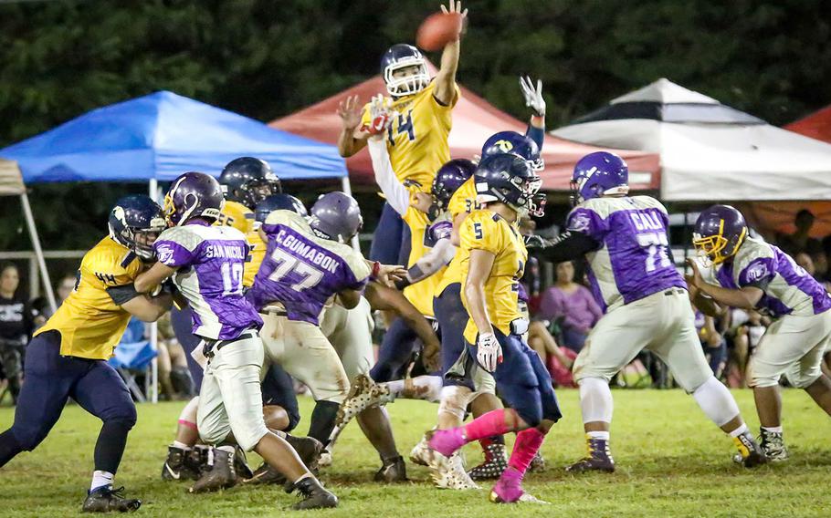 Guam High's Nicholas Keefe goes up to block a George Washington extra-point try after the Geckos' second touchdown.