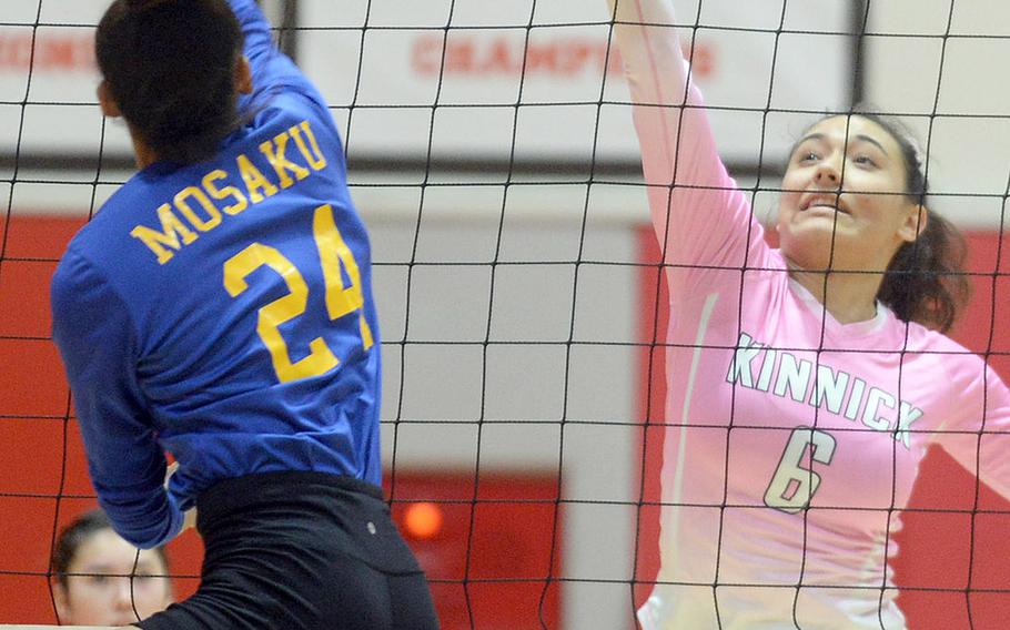 Christian Academy Japan's Mari Mosaku and Nile C. Kinnick's Charley "Anela" Lau battle for the ball at the net during Tuesday's Kanto Plain girls volleyball match, won by the Red Devils in four sets.