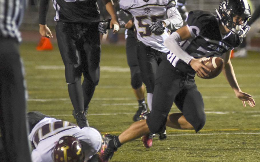 Zama's Luke Singer slithers through a Matthew C. Perry tackle for a 12-yard touchdown run.

