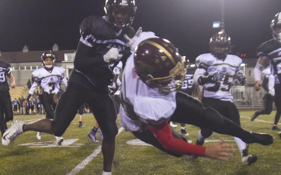 Matthew C. Perry's Eli Carrea is knocked out of bounds by Zama's defense.