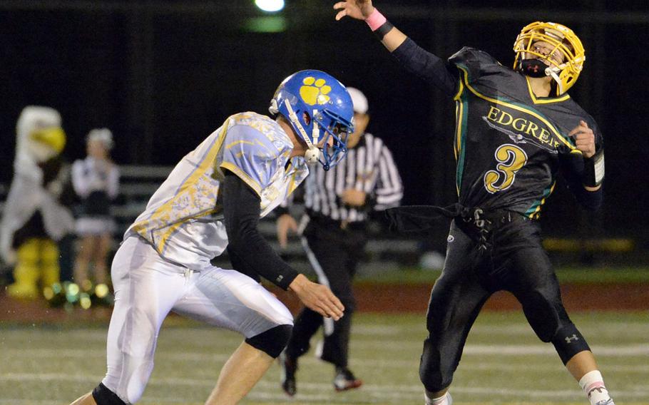 Yokota's Austin Fisher forces a hurried throw from Robert D. Edgren quarterback Dylan Tomas.