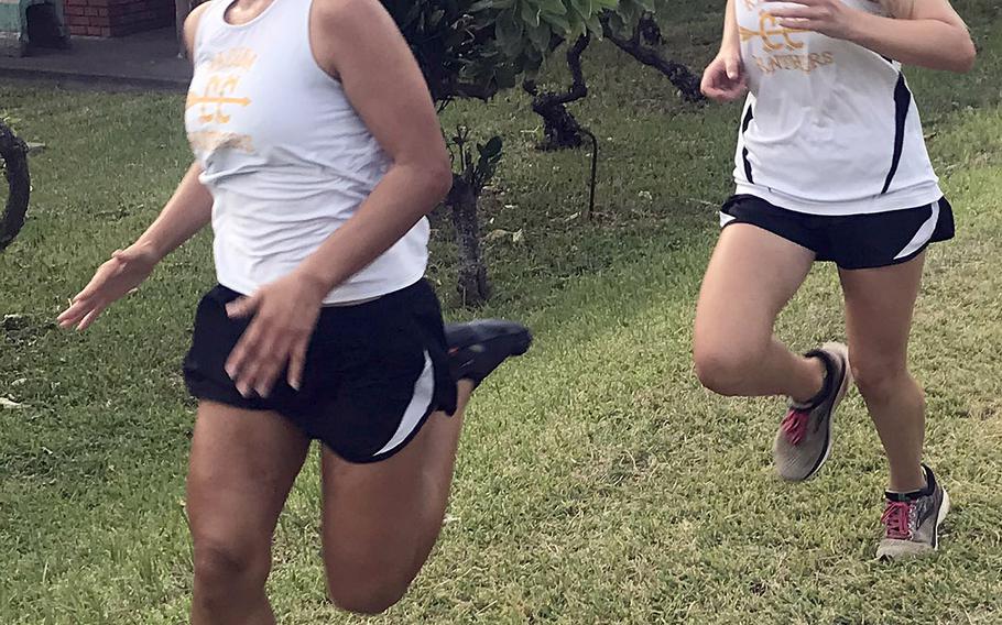 Girls varsity champion Isamar Vargas and middle-school champion Sierra Taysom cross the finish line almost together.