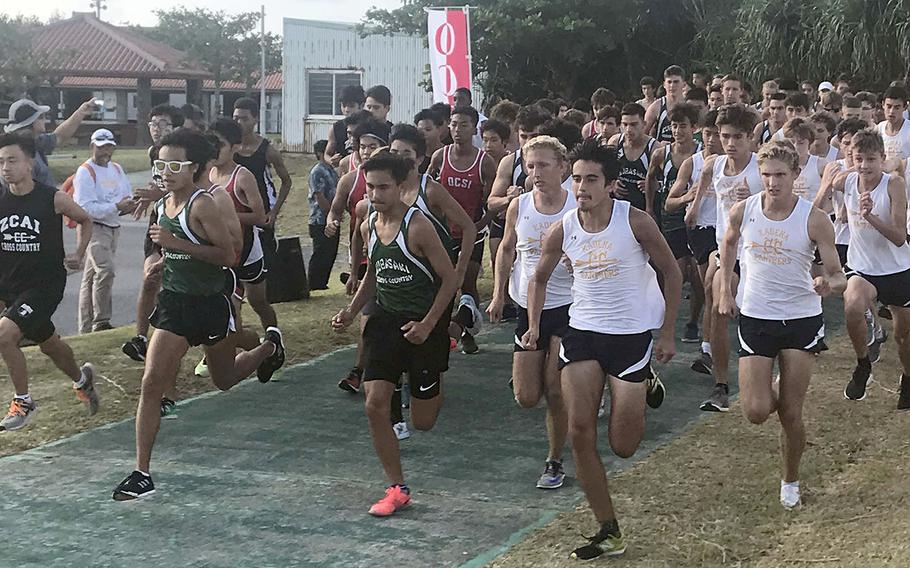 Boys runners dash off the start line of Friday's Okinawa district cross country finals at Cape Zanpa.