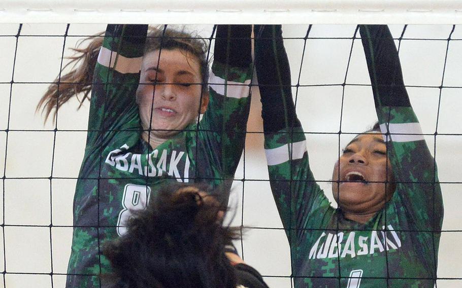 Kubasaki's Abby Robinson and Risha McGriff double block against Ginowan Kogyo during Saturday's matches in the 9th Okinawa-American district volleyball friendship festival at Risner Fitness & Sports Center, Kadena Air Base. The Dragons lost in two sets.
