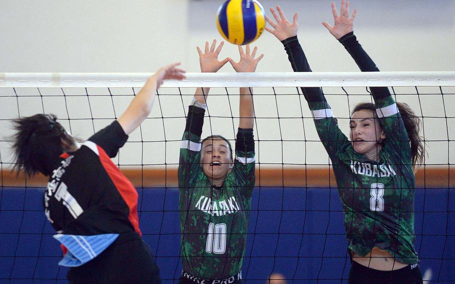Kubasaki's Alyssa Alvarado and Abby Robinson double block against Ginowan Kogyo during Saturday's matches in the 9th Okinawa-American district volleyball friendship festival at  Kadena Air Base. The Dragons lost in two sets.