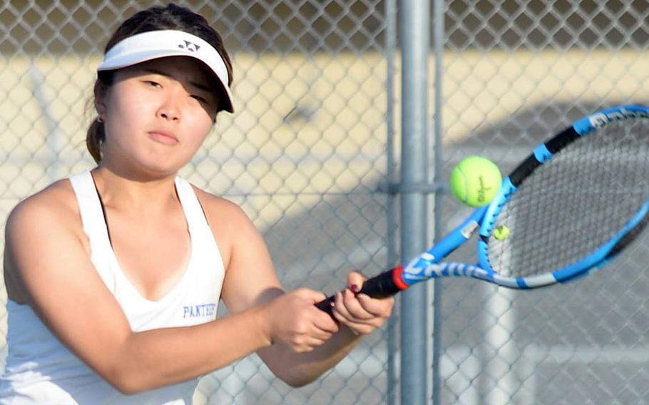 Yokota's Stacy Morioka hits a backhand return during Thursday's DODEA-Japan tennis finals girls doubles match. Morioka and her partner Danica Setka beat Nile C. Kinnick's Aleigh Lamis and Amary Perfecto 6-4.