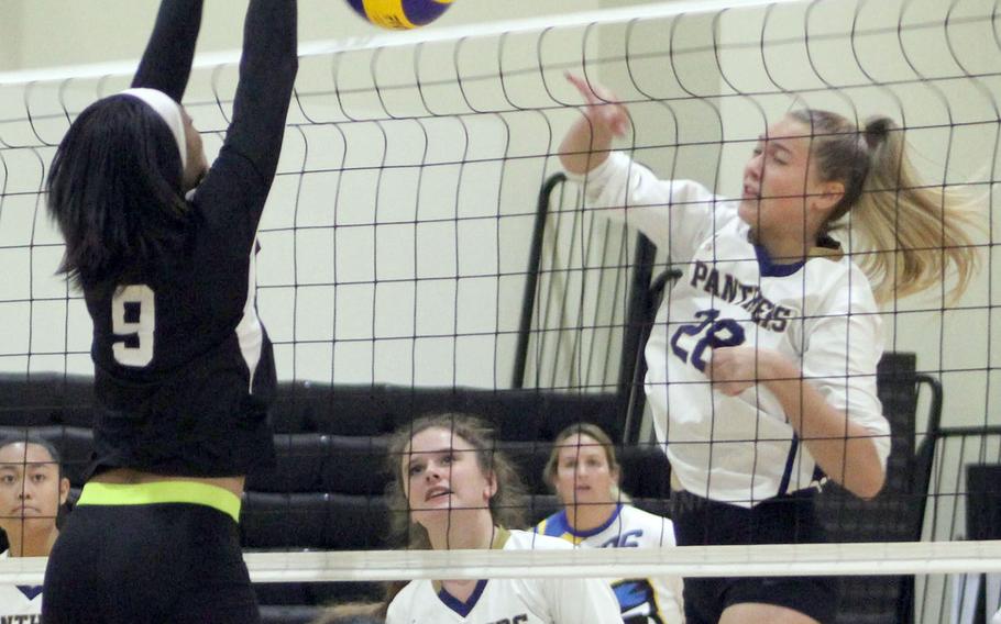 Guam High's Eden French tries to spike past Humphreys' Natalie Goode during Thursday's Far East Division I volleyball tournament pool match. The Blackhawks won in two sets.