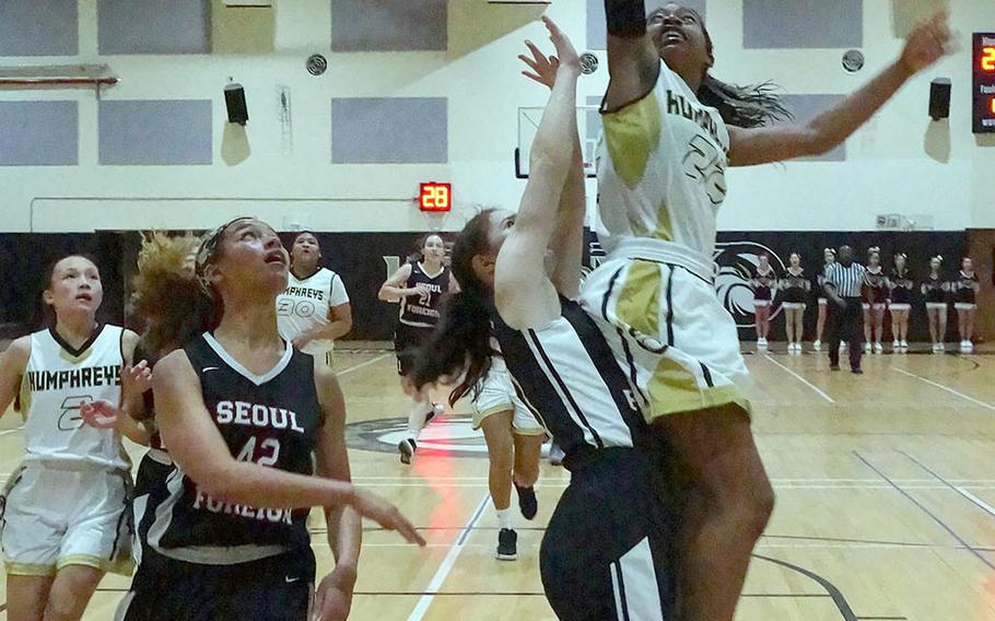 Humphreys' Jaylynn Knight goes up for a shot against Stella Nas and Mya Rolison of Seoul Foreign. The Blackhawks won 53-28. Knight and Rolison played together last season at Seoul American, now closed.