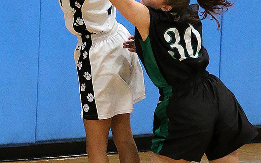Osan's Athena Riddick and Daegu's Lexie Berry battle for the ball during Friday's Korea girls basketball game. The Warriors won 57-14.