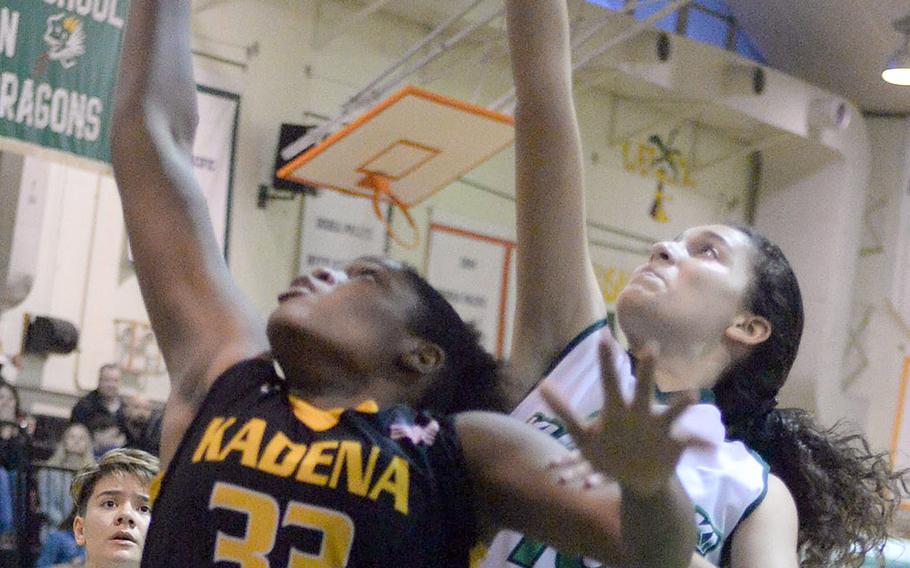 Kadena's Alexis Boyer and Kubasaki's Sophie Grubbs sky for a rebound during Friday's Okinawa girls basketball game. The Panthers won 45-15.