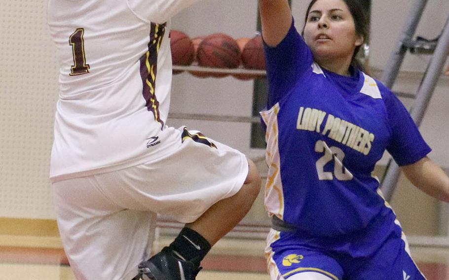 Matthew C. Perry's Jialee Asperer goes up for a shot against Yokota's Aaliyah Velasquez during Friday's DODEA-Japan girls basketball game. The Panthers won 56-23.