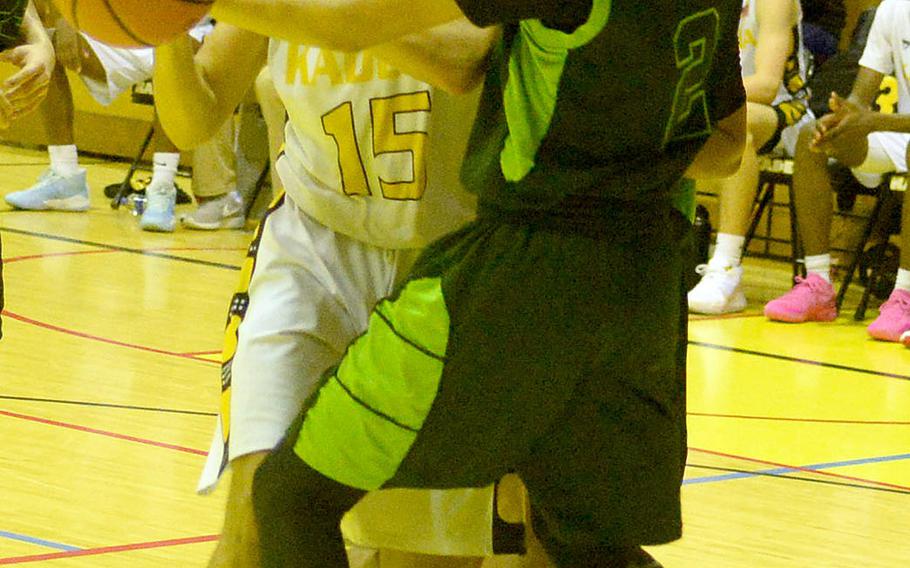 Kadena's Beau Black battles Kubasaki's Erik Camacho for the ball during Friday's Okinawa boys basketball game. The Panthers won 76-43.