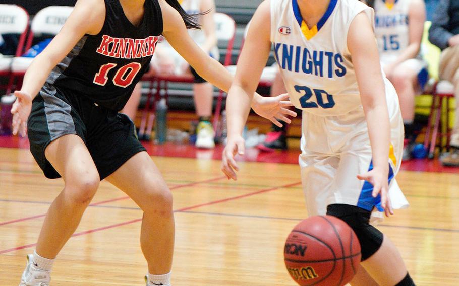 Christian Academy Japan's Mitsuki Hishinuma tries to dribble past NIle C. Kinnick's Mikaila Joi Miranda during Thursday's Kanto Plain girls basketball game. The Knights won 46-28.