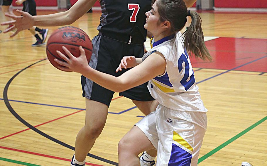 Christian Academy Japan's Rachel Nelson passes the ball past Nile C. Kinnick's Amyka Jones during Thursday's Kanto Plain girls basketball game. The Knights won 46-28.