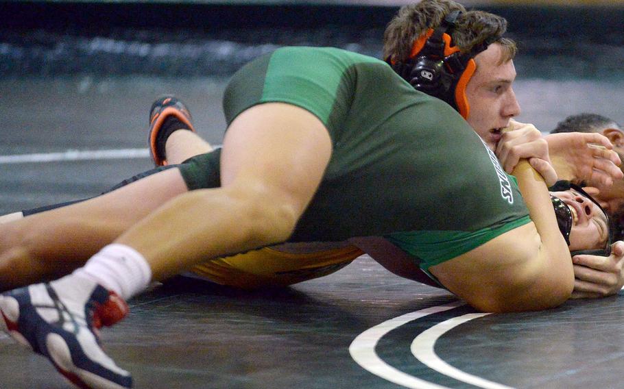Kadena's Kurt Chapman pins Kubasaki's Jeffrey Owens in 1 minute, 1 second at 129 pounds during Wednesday's Okinawa wrestling dual meet. The Dragons won the meet 38-24.