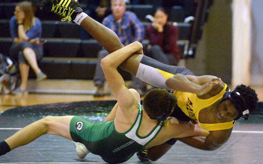 Kubasaki's Adrian Misenhimer and Kadena's Crisean Covington go tumbling to the mat at 141 pounds during Wednesday's Okinawa wrestling dual meet. Covington won a 13-10 decision, but the Dragons won the meet 38-24.