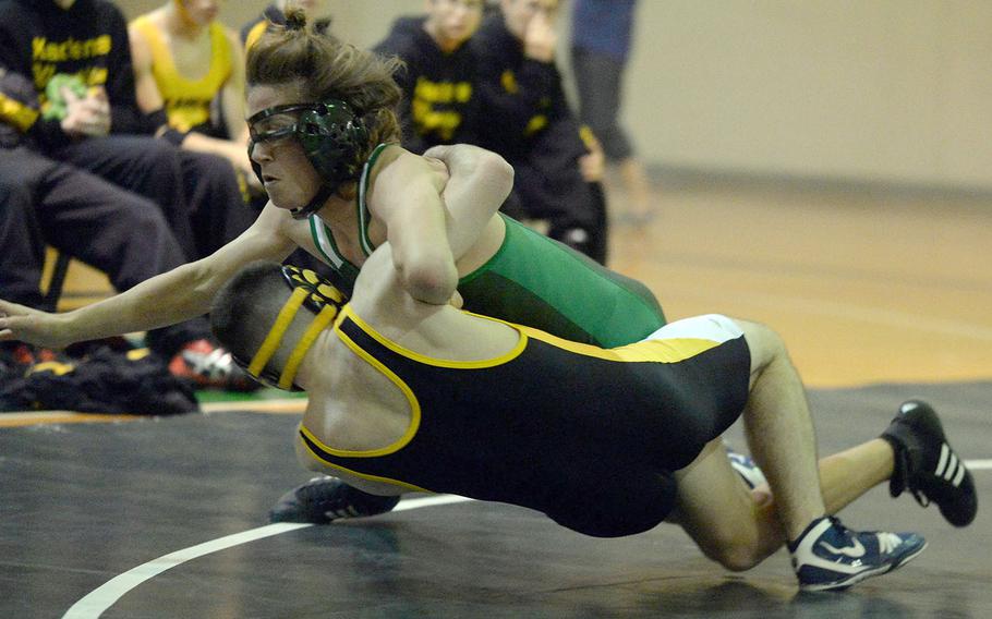 Kubasaki's Colin Lundberg works a 16-5 technical fall in 2 minutes, 25 seconds over Kadena's Caleb Marks at 148 pounds during Wednesday's Okinawa wrestling dual meet. The Dragons won 38-24.