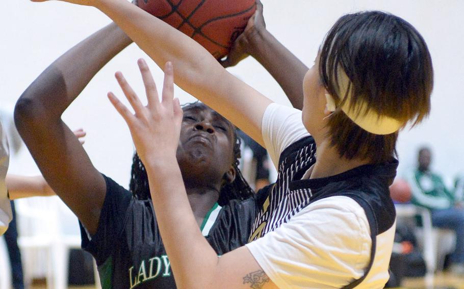 Daegu's Jya Van shoots against Taejon Christian's Sylvia Yun during Friday's Korea Blue girls basketball game. The Warriors won 54-22.